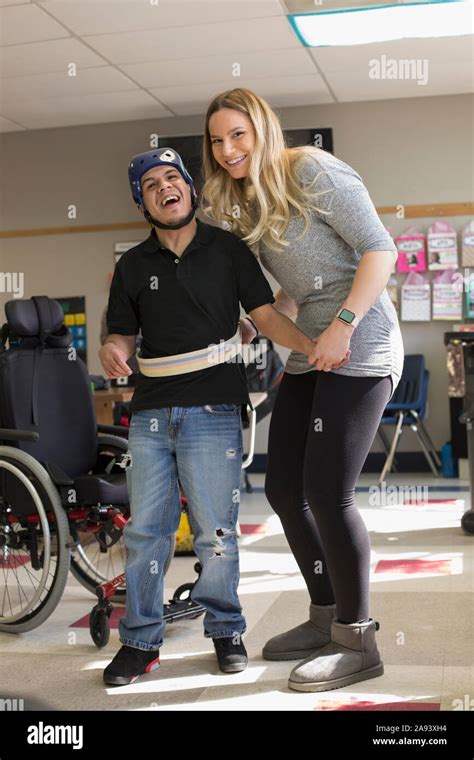 Boy With Spastic Quadriplegic Cerebral Palsy And Teacher At School