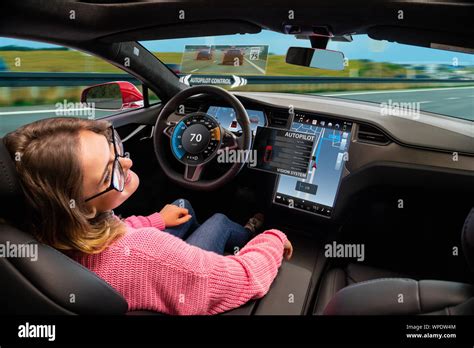 A Woman Resting While Her Car Is Driven By An Autopilot Self Driving Vehicle Concept Stock