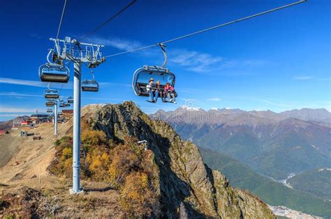People Ride On Chair Ski Lift Of Gorky Gorod Mountain Resort In Autumn