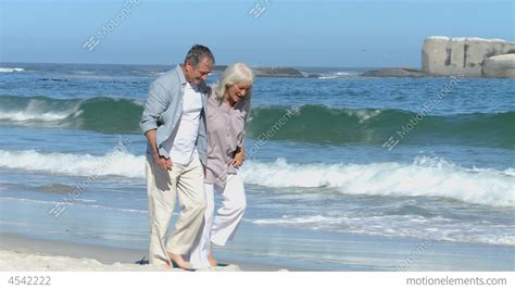 Elderly Couple Walking Along The Beach Stock Video Footage 4542222