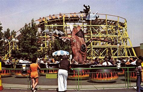 people standing in front of an amusement park ride