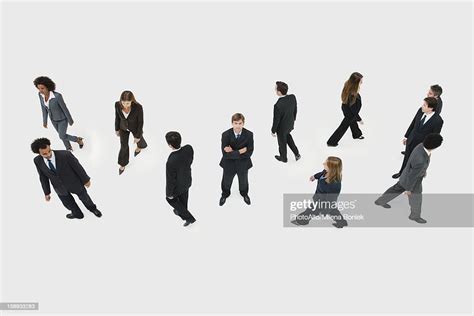 Businessman Standing Still In Midst Of Other Business Professionals On