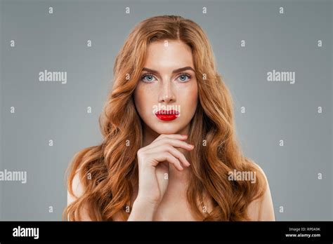 Beautiful Model With Long Curly Red Hair Looking At Camera Wavy Shiny
