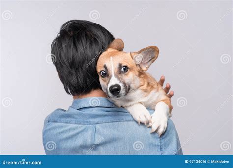 A Man Snuggling And Hugging His Dog Close Friendship Loving In Stock