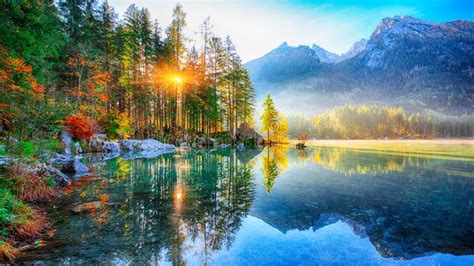 Beautiful Autumn Sunrise Scene With Trees Near Turquoise Water O Stock