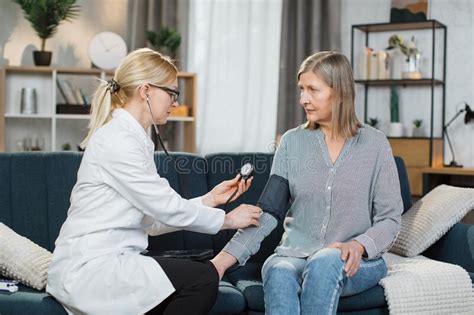 Seniors Hypertension Concept Doctor Measuring Blood Pressure To