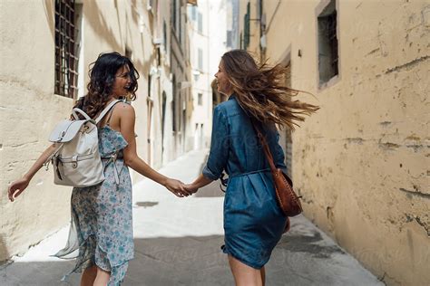 two female best friends walking around and visitng florence ita del colaborador de stocksy