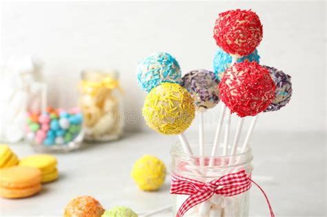 Yummy Bright Cake Pops In Glass Jar Full Of Marshmallows On Table Stock
