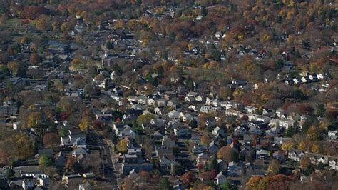 5.5K stock footage aerial video orbit a small town neighborhood in