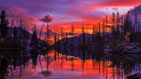 Symmetrical Sunrise Fire Upon An Alpine Lake In Washington State