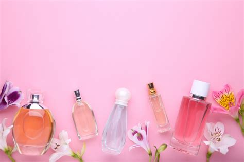 The perfume collection by pairfum. Premium Photo | Perfume bottles with flowers on pink