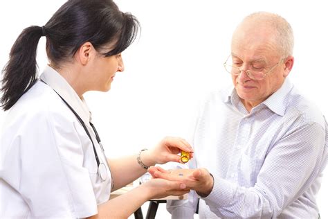 Doctor Giving Medicines To A Senior Man Aw Health Care
