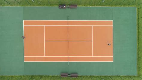 People Are Playing Tennis On Court Aerial Vertical Top View Drone Is