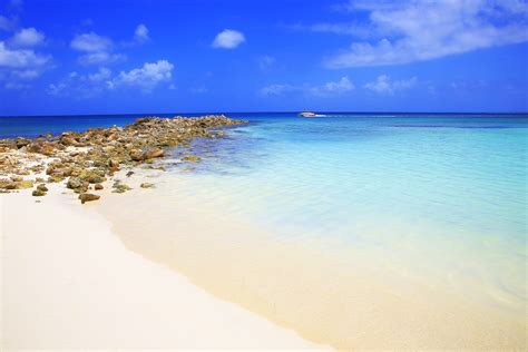 Tropical Turquoise Beach Stone Pier And Speedboat Aruba Caribbean