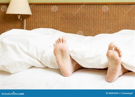 womans feet sticking out of blanket on bed royalty free stock image image 38303436