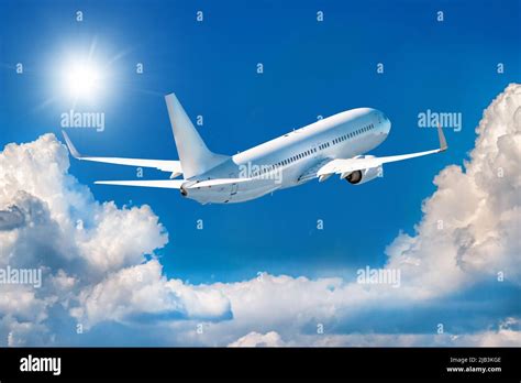 White Passenger Airplane Is Climbing In The Air Above Picturesque