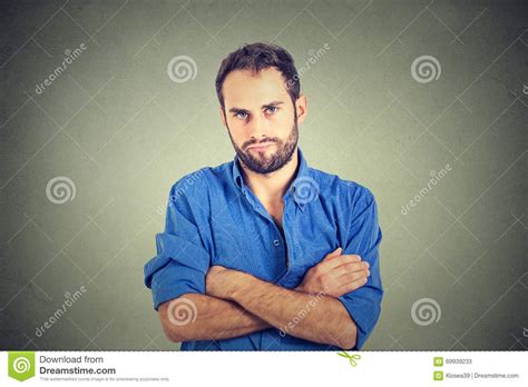Angry Grumpy Female Dressed Casually Keeping Arms Folded Looking At Camera With Strict And