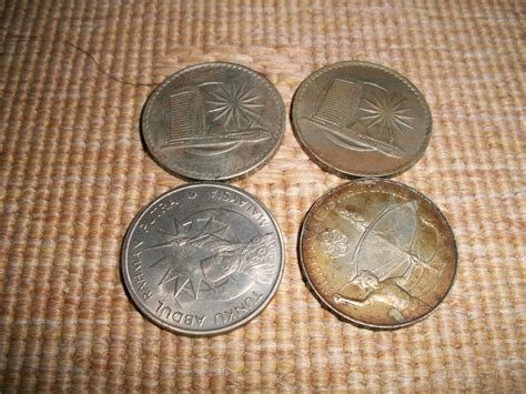 The obverse also features the coin's weight, purity and mint year as well as the. collectible items: 1 lot of Malaysia old Coin (4pcs)