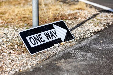 One Way Street Sign Lying On The Side Of A Roadway Stock Image Image