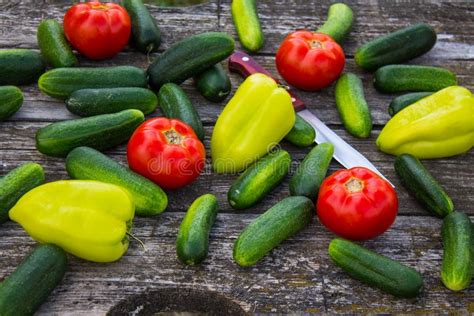 Fresh Cucumbers Tomatoes And Peppers On An Old Wooden Table Stock Image