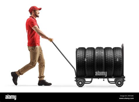 Delivery Man Pushing A Hand Truck With Tires Isolated On White