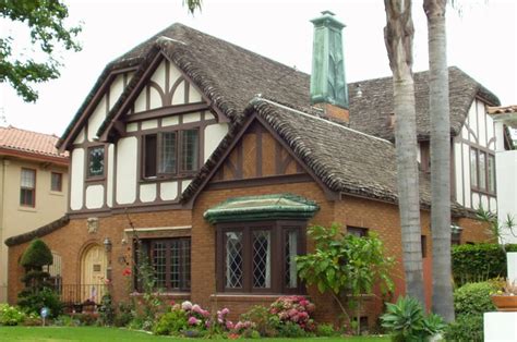 The american tudor revival style also overlaps with the arts & crafts movement, sharing similar characteristics such as simplicity, materials inspired by nature, and an emphasis on craftsmanship. American Tudor complete with faux thatched roof | Homes ...