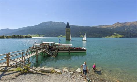 The village used to be inhabited by hundreds of people before it was flooded to create an artificial lake for a hydroelectric plant. Der versunkene Turm in See - Symbol des Reschensees im ...