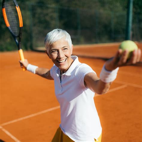Senior Tennis â€“ Pretty Mature Woman Serving Ball In Tennis Stock Image Image Of Female