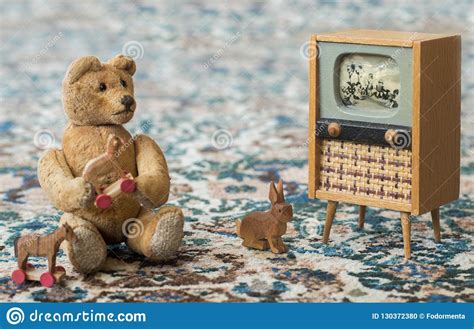 Small Teddy Bear Watch Cartoons In The Television Scene