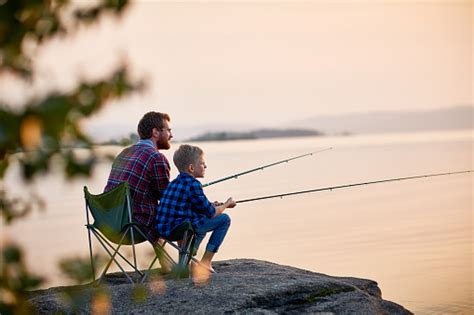 Father And Son Enjoying Fishing Together Stock Photo Download Image