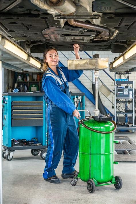 Female Mechanic Working Under Car On Hydraulic Lift Stock Image Image