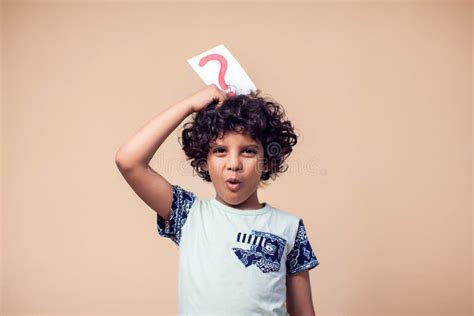 A Portrait Of Kid Boy Holding Cards With Question Mark Children And