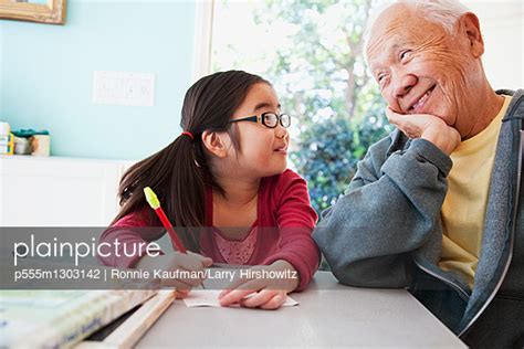 Japanese Grandfather Helping Granddaughter With Homework Stock Image Everypixel