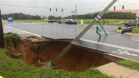 Sinkhole In Florida Opens Up Along Roadway Taking Down Traffic Lights