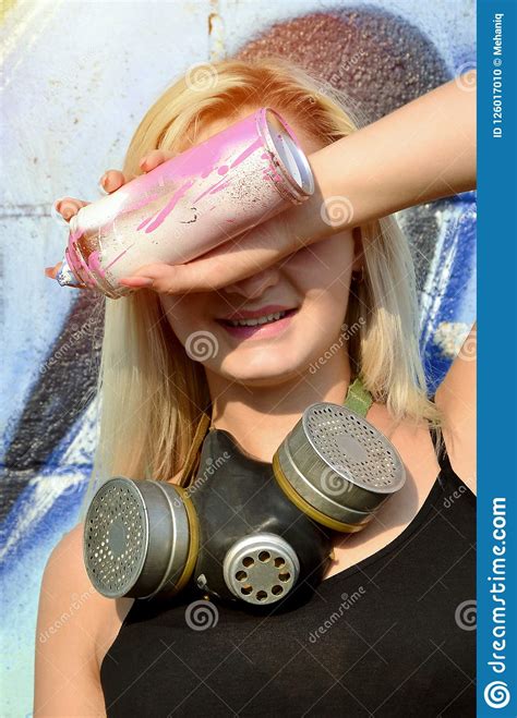 Young And Beautiful Smiling Girl Graffiti Artist With Gas M Stock Photo