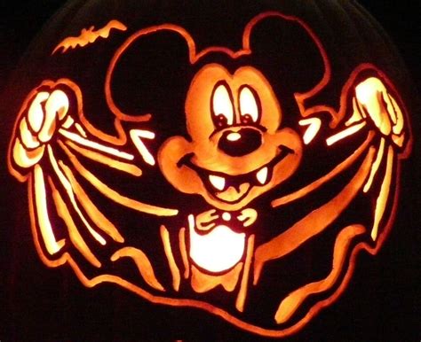 A Mickey Mouse Pumpkin Carved Into The Shape Of A Head With Arms And
