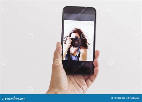Young Woman Taking A Self Portrait In Front Camera Of The Mobile Phone