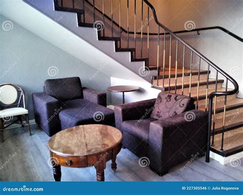 Cosy Interior With Stairs Chairs And Table In Hall Stock Photo Image