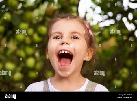 Portrait Of A Cute Little Girl Making An Excited Face With Her Mouth