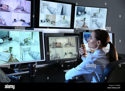 Security Guard Monitoring Modern Cctv Cameras In Surveillance Room