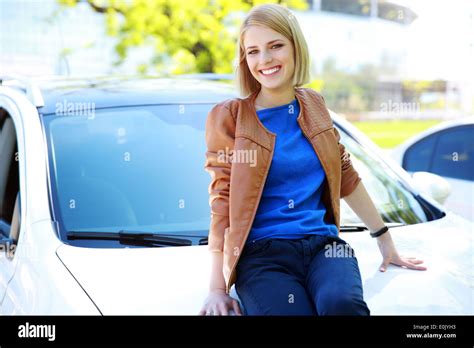 Young Woman Sitting On Car Bonnet Hi Res Stock Photography And Images