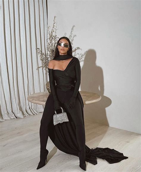Kim Kardashian Flaunts A Balenciaga Outfit With A Cape And Sparkly Handbag