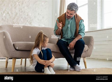 Strict Father Scolding Sad Daughter For Bad Behavior At Home Stock