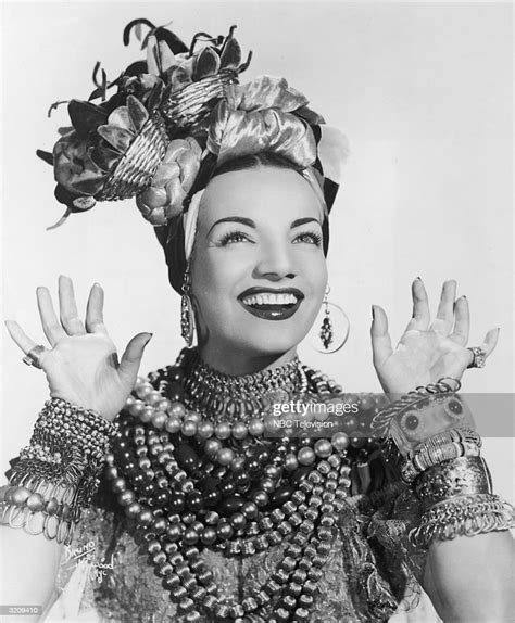 Studio Portrait Of Brazilian Actor Carmen Miranda Smiling While News