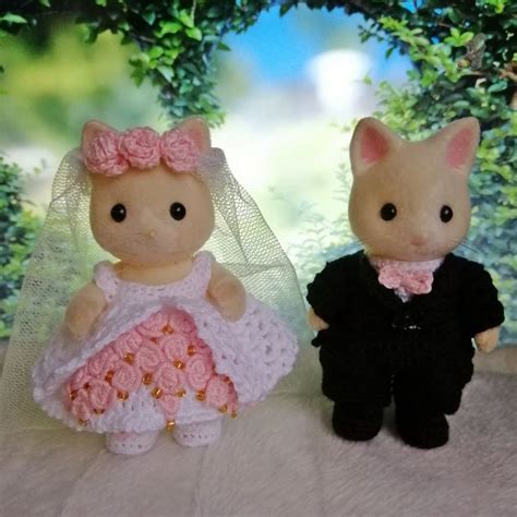 Two Stuffed Animals Dressed Up In Wedding Attire
