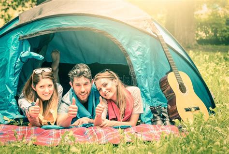 Group Of Best Friends With Thumbs Up In Camping Tent Stock Image