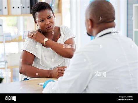 Woman Showing Her Doctor Her Shoulder Injury African American Patient