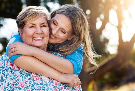 When Shes Happy Im Happy Portrait Of A Happy Mature Woman Hugging Her Mother Outdoors Stock