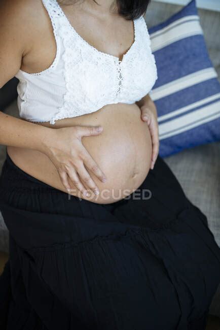 Unrecognizable Pregnant Holds Her Belly Close Up View Of Naked Tummy