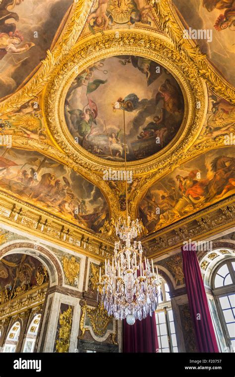 Impressive Chandelier And Painted Ceiling In The Palace Of Versailles